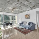 a living room with furniture a table and chairs