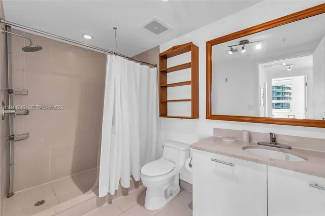 a bathroom with a toilet sink and shower