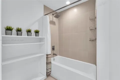 a bathroom with a bathtub and shower