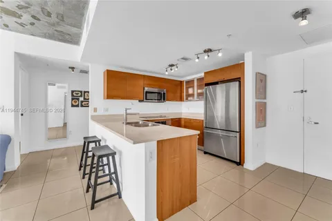 a kitchen with stainless steel appliances a refrigerator and a stove
