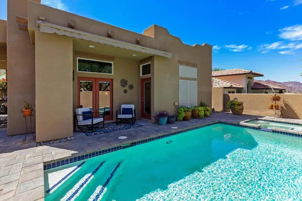 a view of a house with backyard porch and sitting area