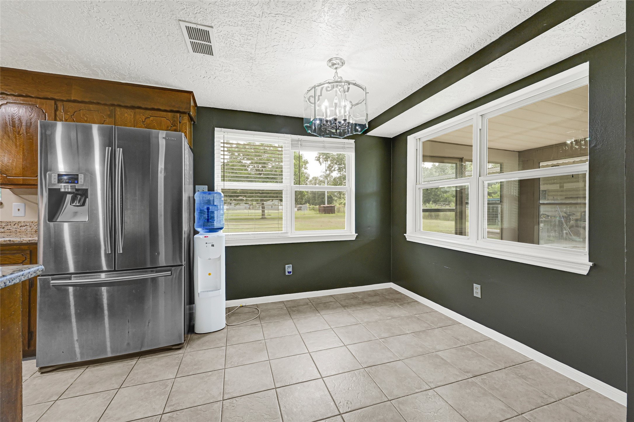 20135 Timber Line Lane New Caney, TX 77357 - Photo 12 of 30 a kitchen with windows and refrigerator