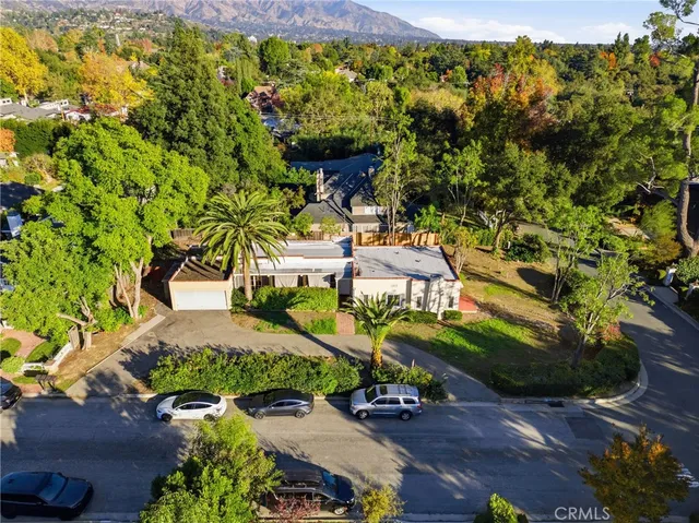 an aerial view of a house with a yard basket ball court and outdoor seating