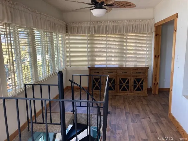 a white bed sitting in a bedroom next to a window