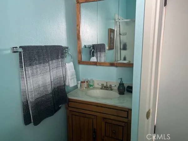 a white bed sitting in a bedroom next to a window