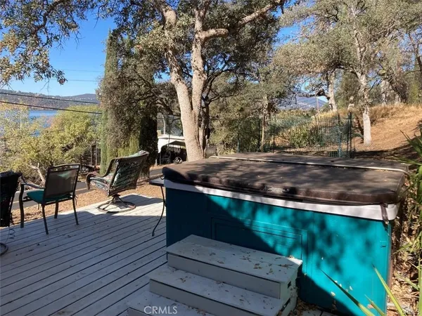 a view of a terrace with couches and wooden fence