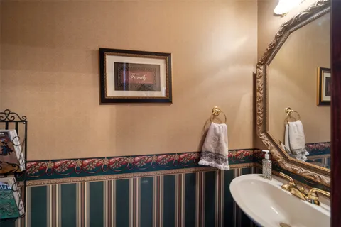 a bathroom with a sink a mirror and vanity