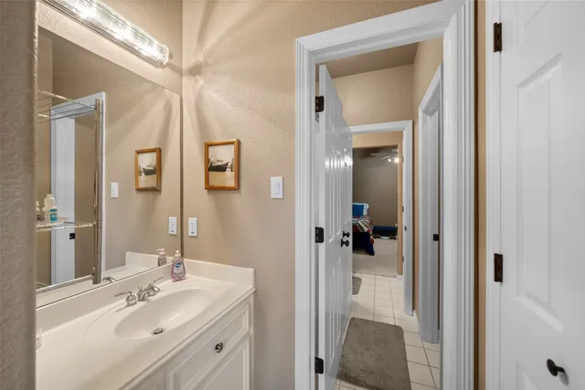 a bathroom with a sink vanity and mirror