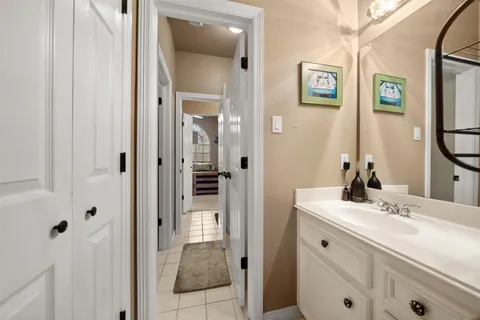 a bathroom with a sink vanity and a mirror