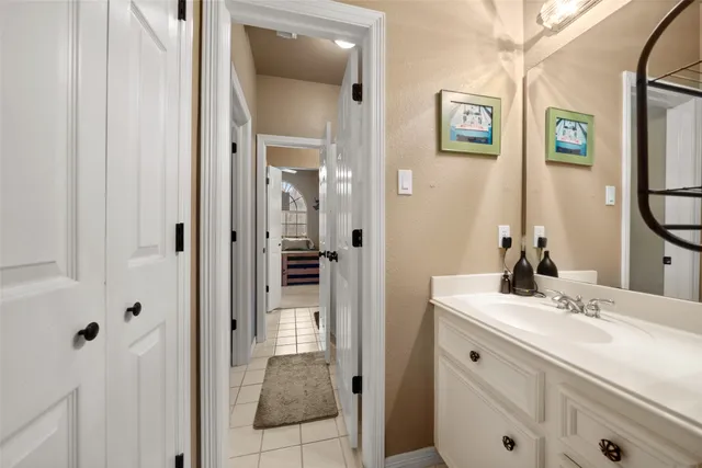 a bathroom with a sink vanity and a mirror