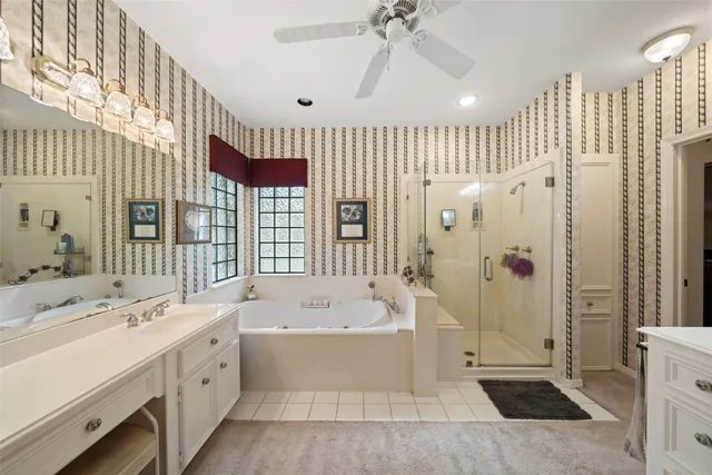 a bathroom with a double vanity sink a mirror and a bathtub