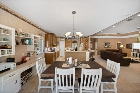 a view of a dining room with furniture and chandelier