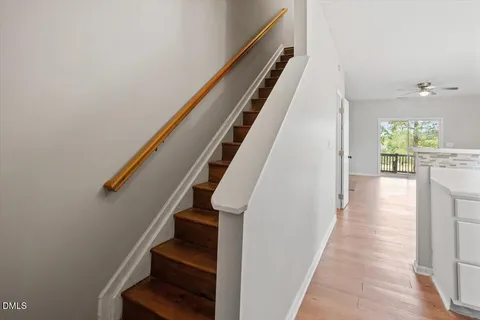 a view of entryway and hall with wooden floor