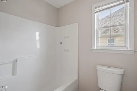 a bathroom with a toilet a sink and a shower
