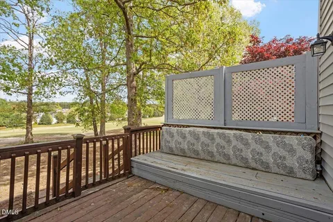 a view of a street with wooden fence and trees
