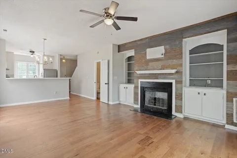 a view of an empty room with a fireplace and a window