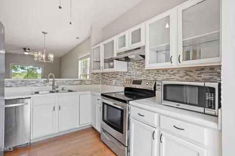 a kitchen with stainless steel appliances granite countertop a stove and a sink