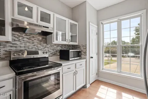 a kitchen with stainless steel appliances a stove sink and cabinets