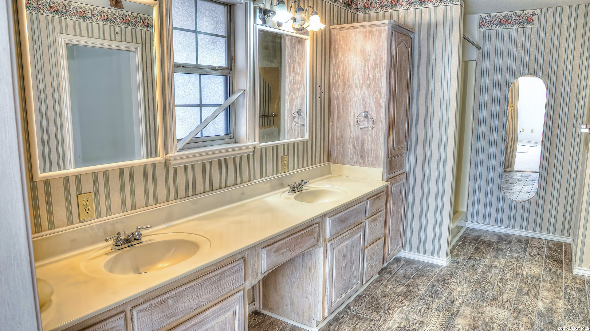 196 Canal Cir Drive Rio Frio, TX 78879 - Photo 45 of 56 a bathroom with a granite countertop sink and a large mirror