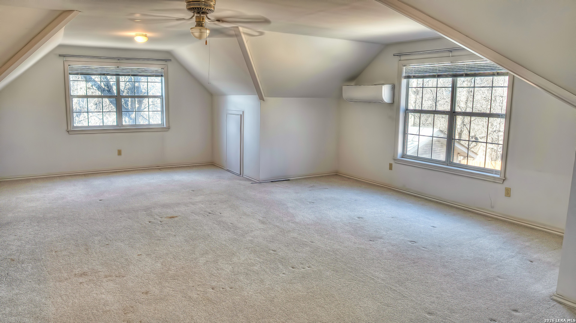 196 Canal Cir Drive Rio Frio, TX 78879 - Photo 51 of 56 an empty room with windows and chandelier fan