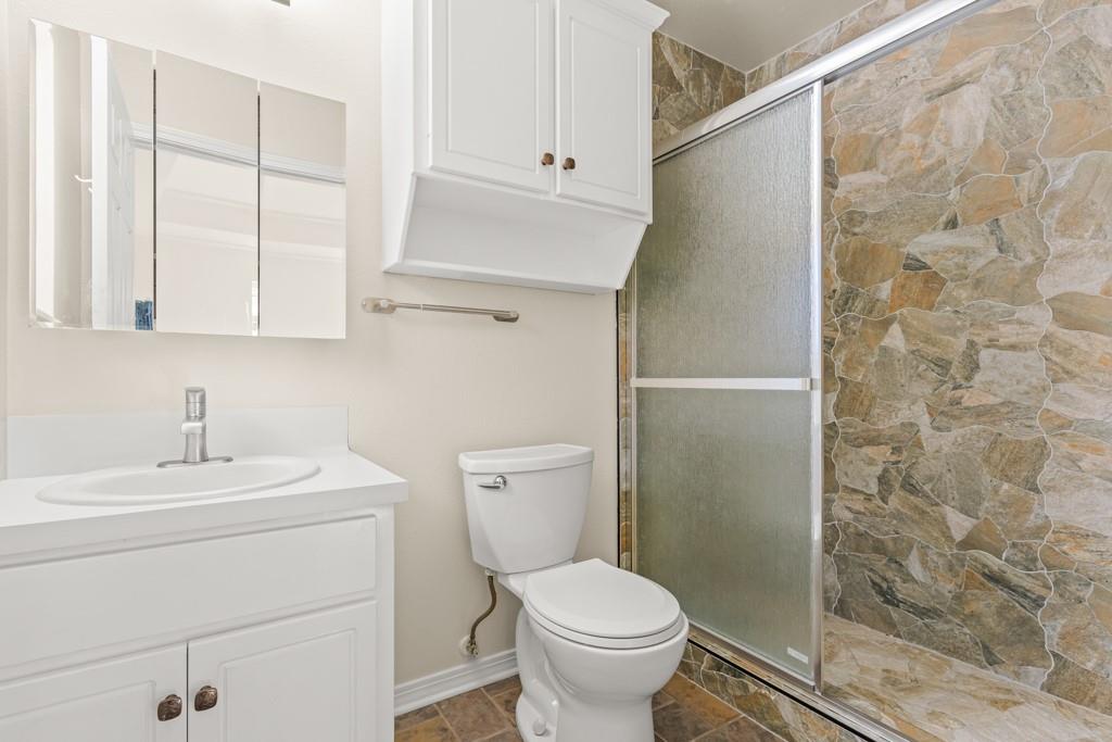 804 Alta Street Longview, TX 75604 - Photo 13 of 20 a bathroom with a sink a toilet and shower