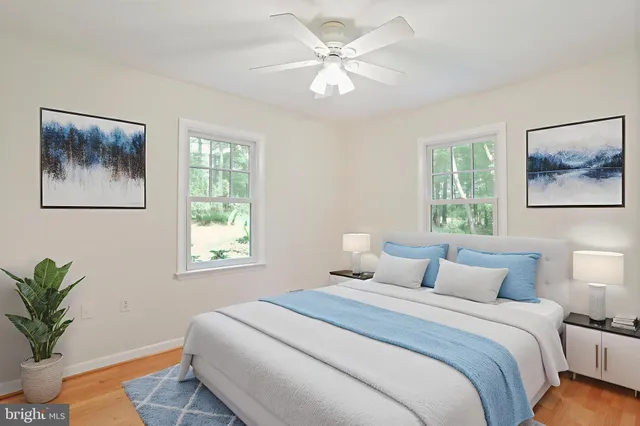 a living room with furniture a window and a potted plant