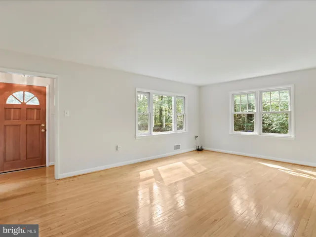 a kitchen with stainless steel appliances granite countertop a sink a stove cabinets and a window
