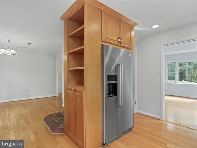 a view of a kitchen with granite countertop stainless steel appliances a stove and a large window