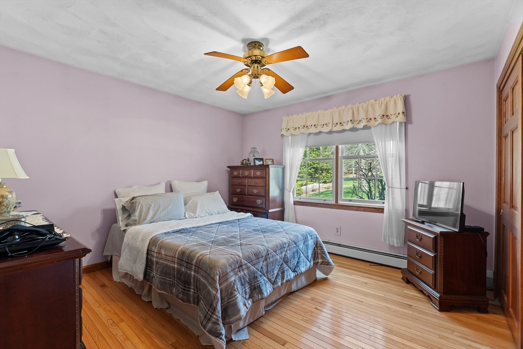 36 High Street Freetown, MA 02702 - Photo 21 of 42 a bedroom with a bed and wooden floor