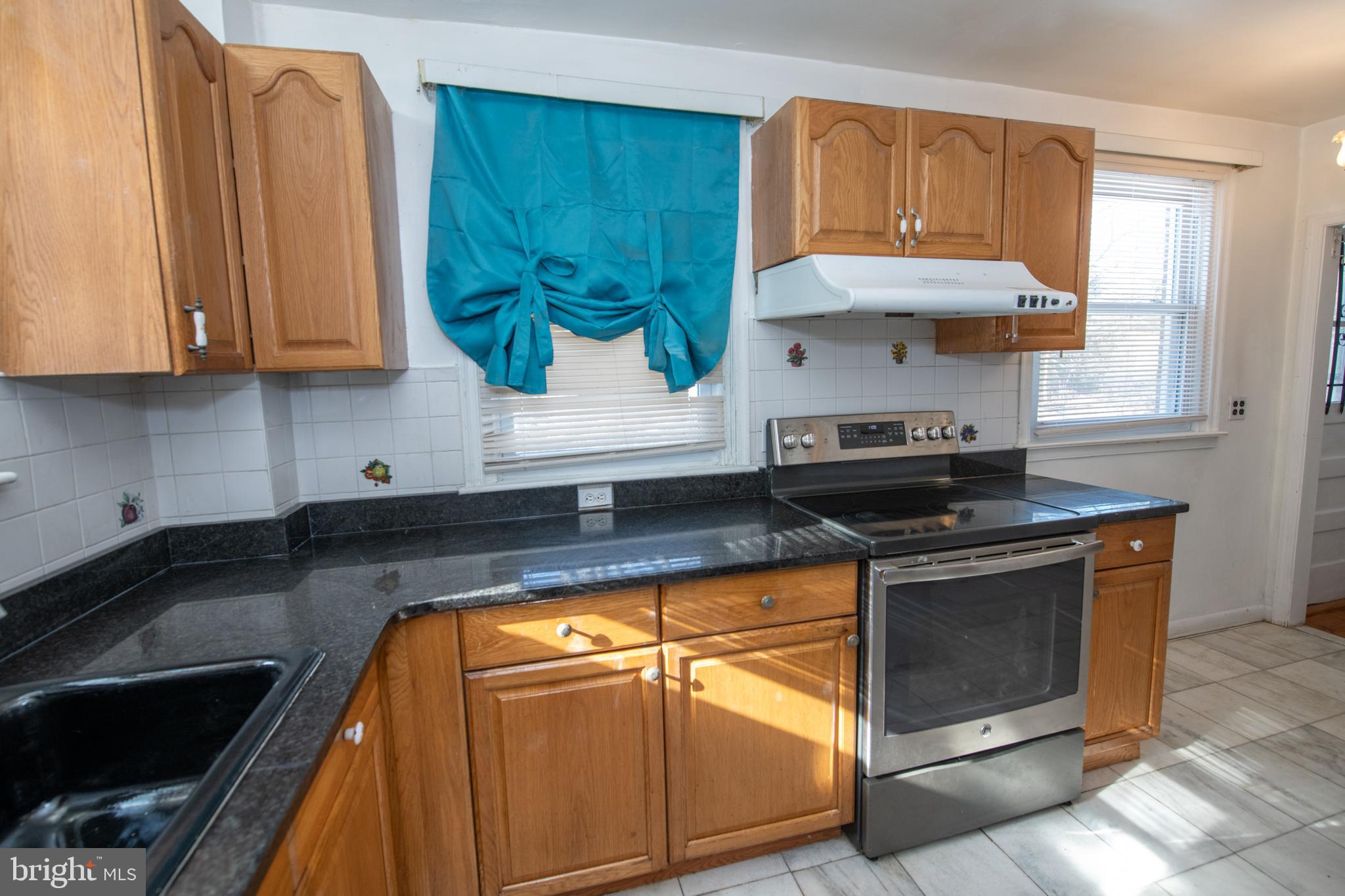 7820 Haines Road Cheltenham, PA 19012 - Photo 13 of 51 a kitchen with granite countertop wood cabinets and stainless steel appliances