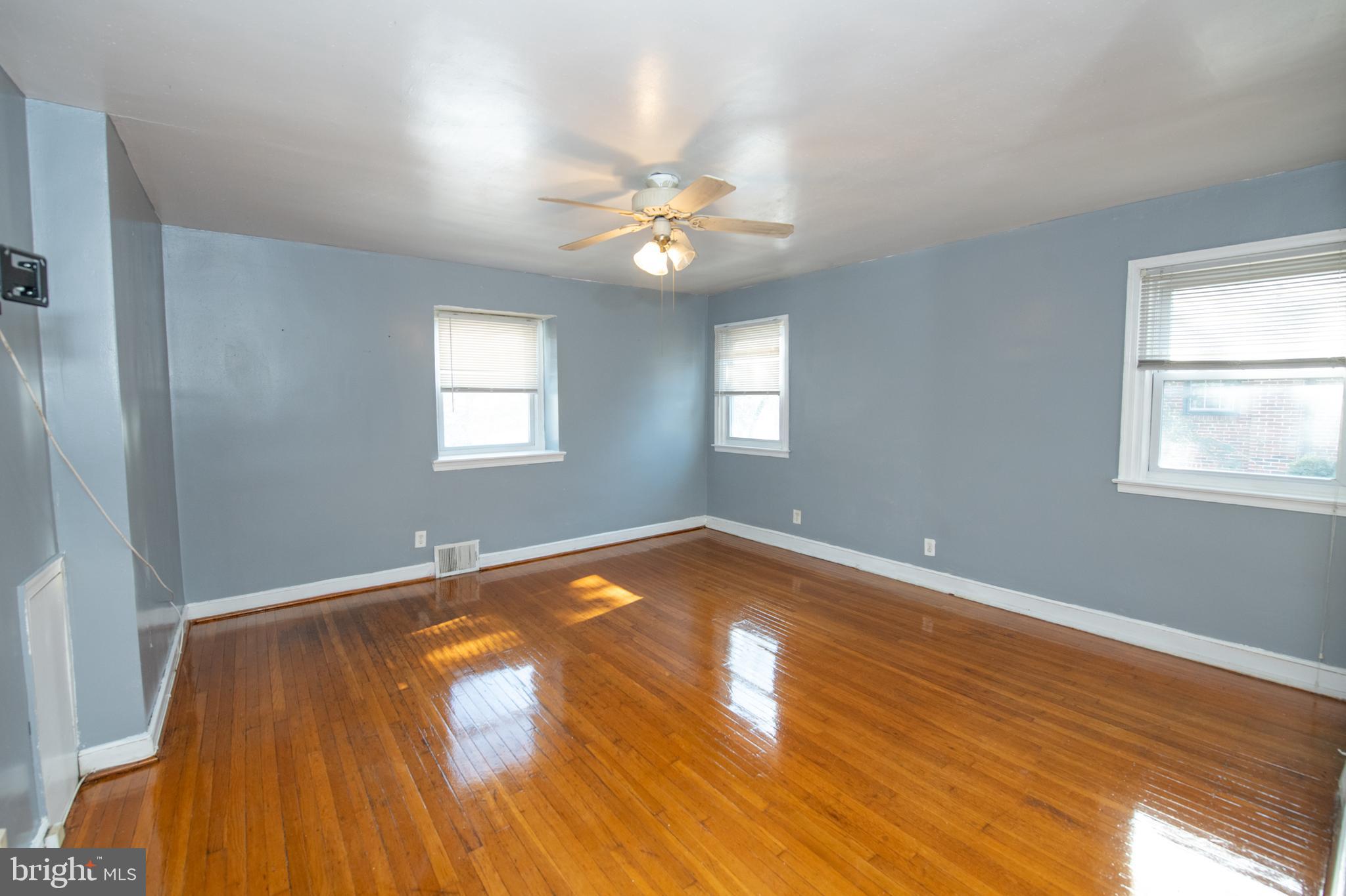 7820 Haines Road Cheltenham, PA 19012 - Photo 22 of 51 an empty room with wooden floor and windows