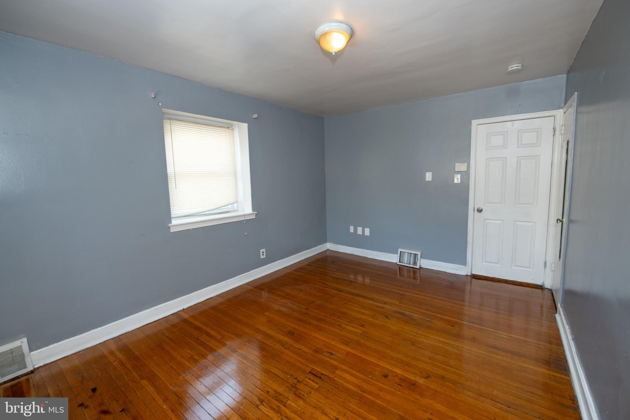 7820 Haines Road Cheltenham, PA 19012 - Photo 27 of 51 an empty room with wooden floor and windows