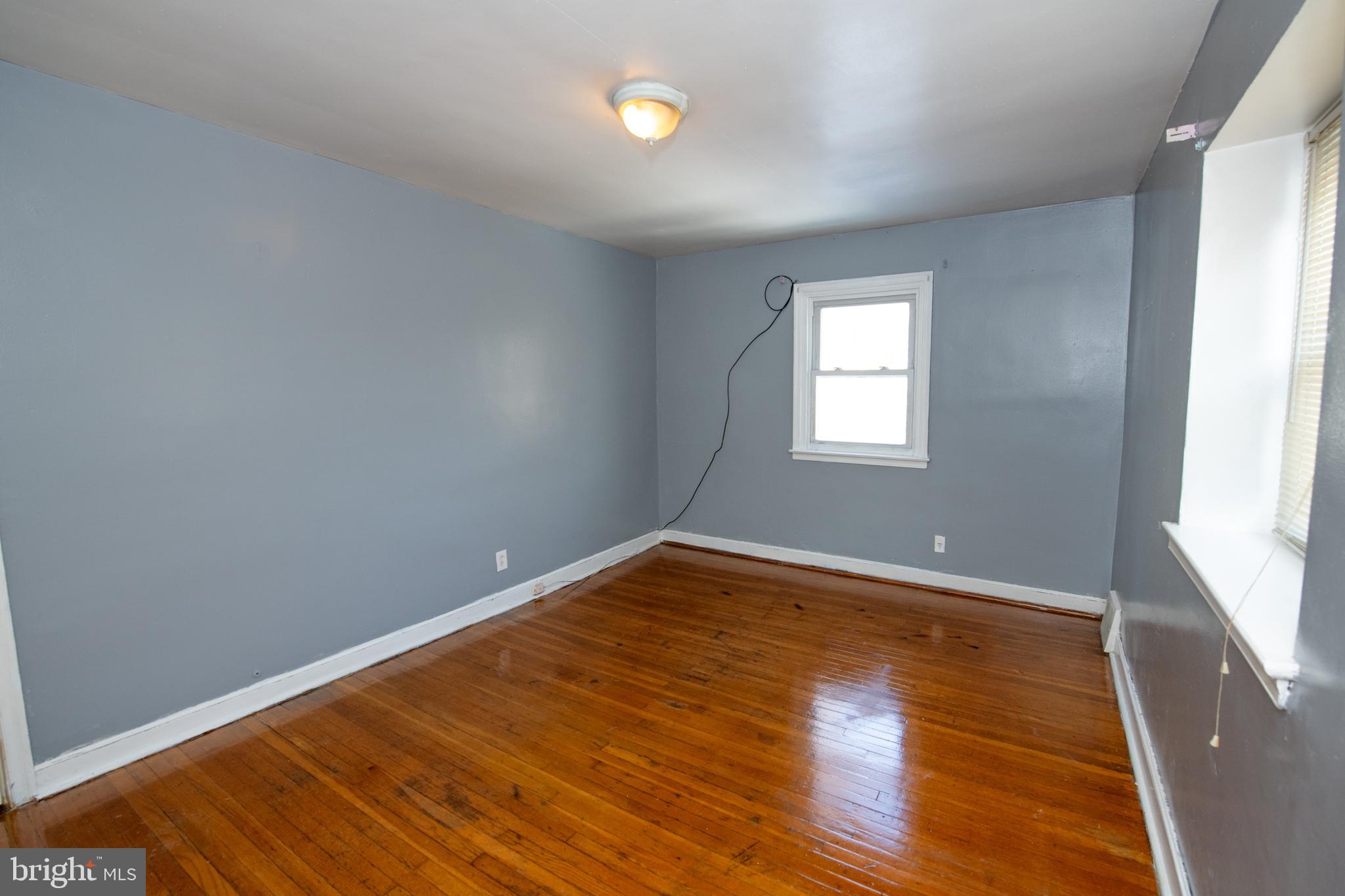 7820 Haines Road Cheltenham, PA 19012 - Photo 29 of 51 an empty room with wooden floor and windows