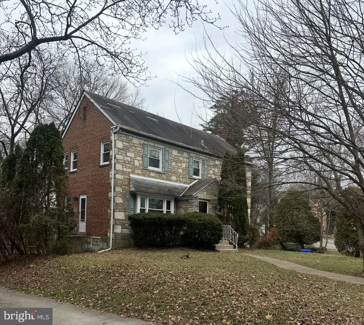 7820 Haines Road Cheltenham, PA 19012 - Photo 51 of 51 a front view of a house with a garden and trees