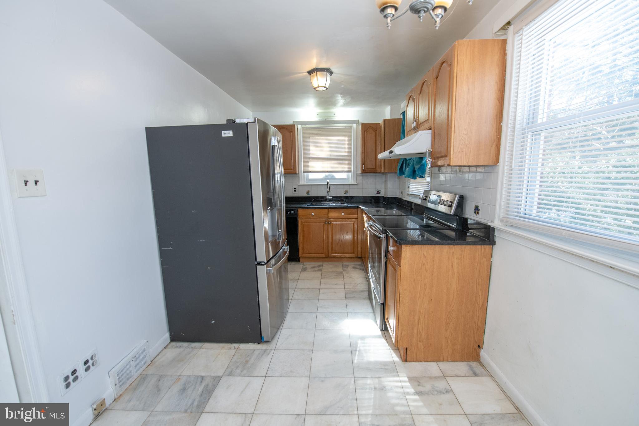 7820 Haines Road Cheltenham, PA 19012 - Photo 10 of 51 a kitchen with stainless steel appliances granite countertop a refrigerator and a sink