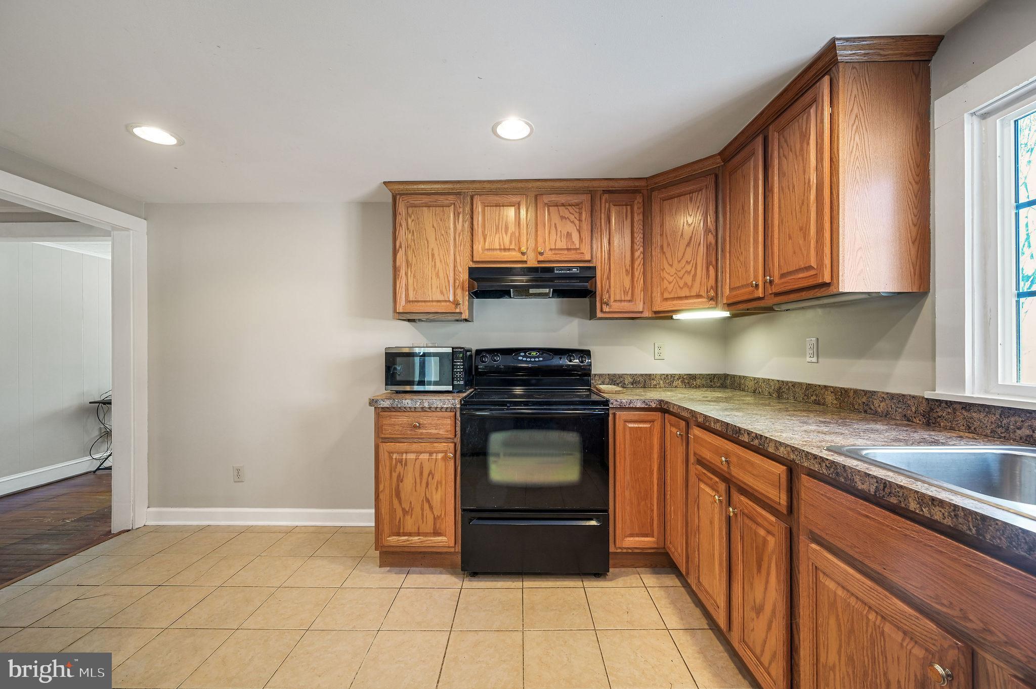 12739 Greensboro Road Greensboro, MD 21639 - Photo 11 of 28 a kitchen with stainless steel appliances granite countertop a stove a sink and a refrigerator