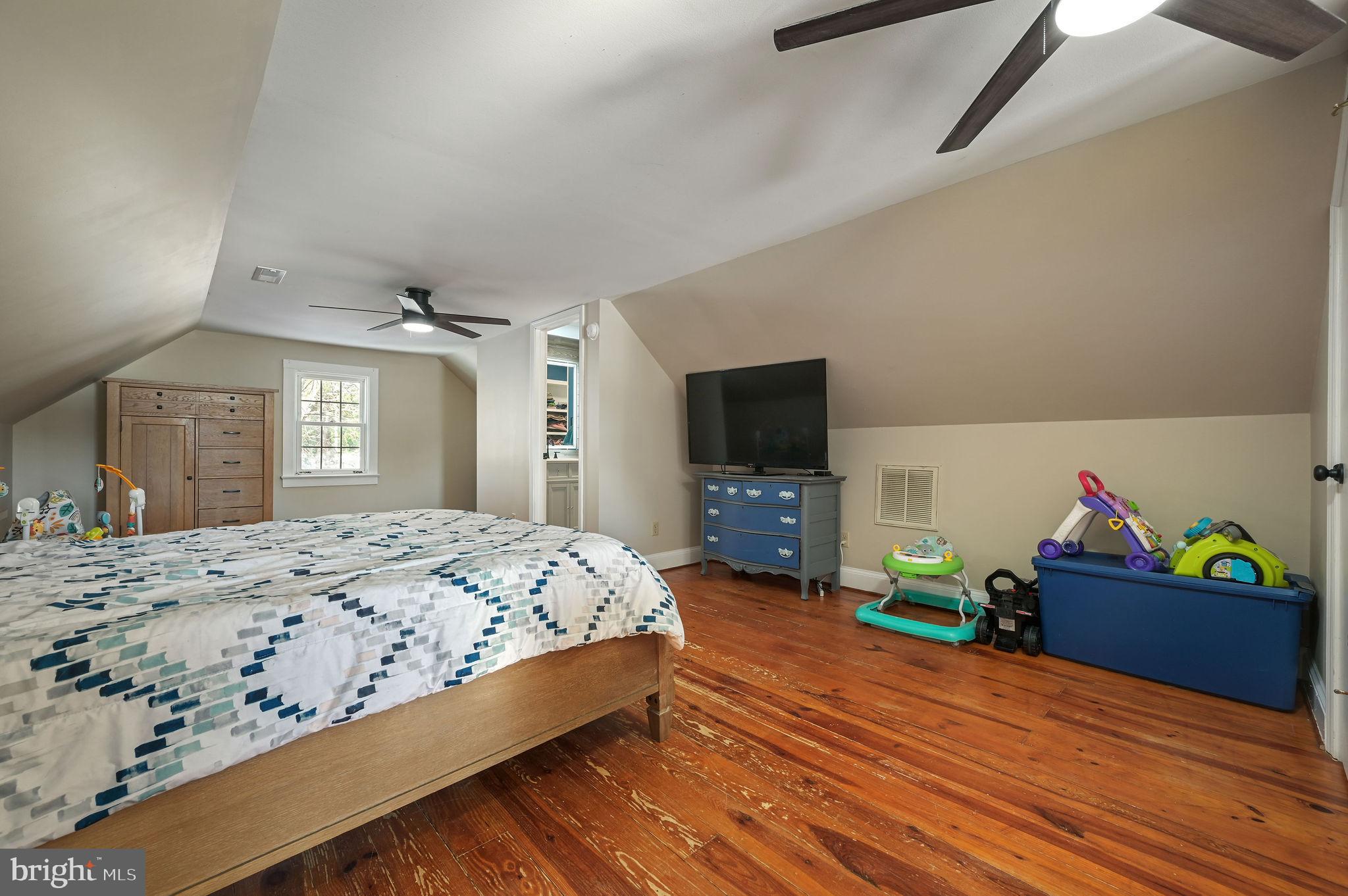 12739 Greensboro Road Greensboro, MD 21639 - Photo 16 of 28 a bedroom with a bed and a flat screen tv