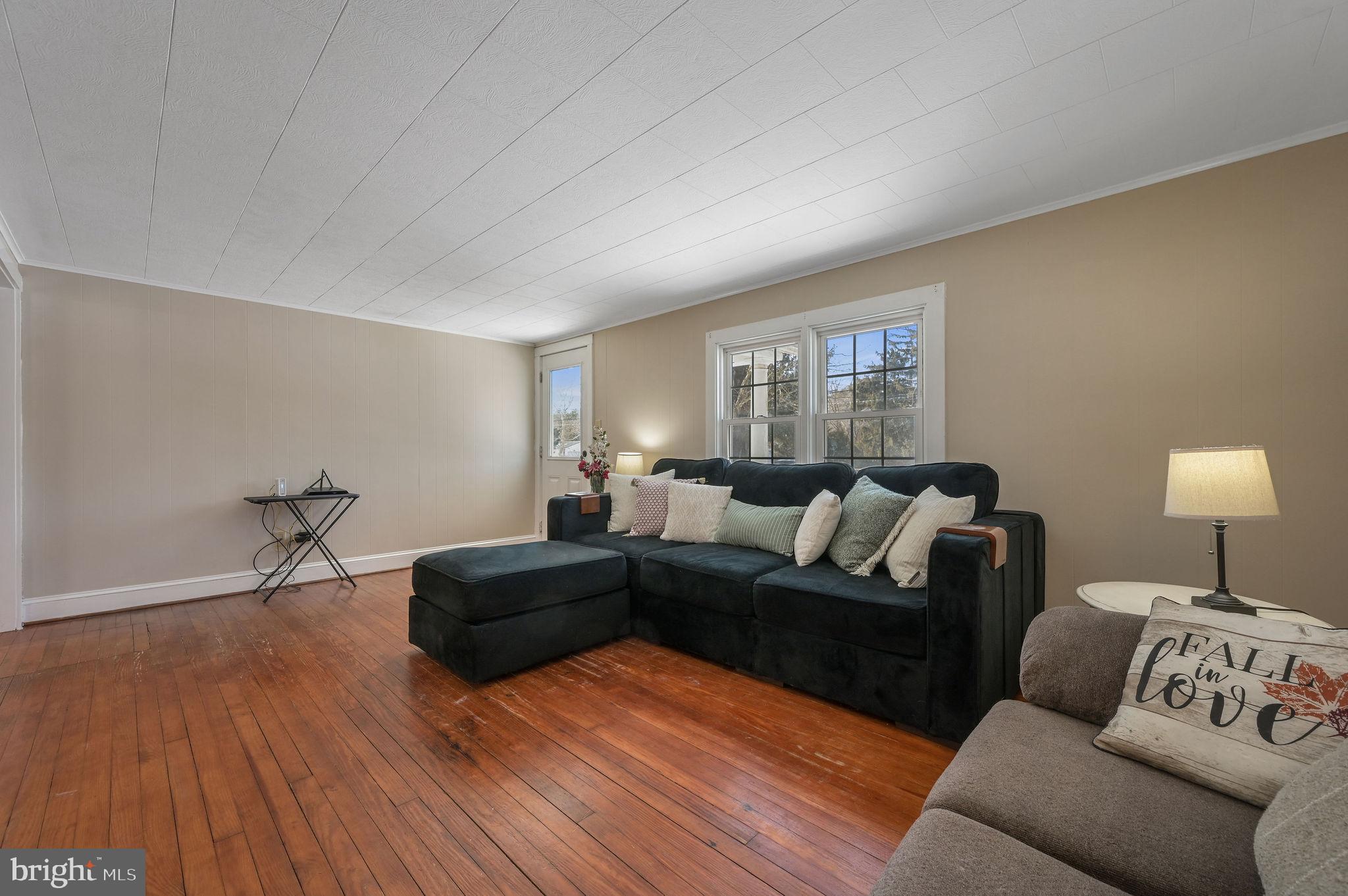 12739 Greensboro Road Greensboro, MD 21639 - Photo 7 of 28 a living room with furniture and a wooden floor
