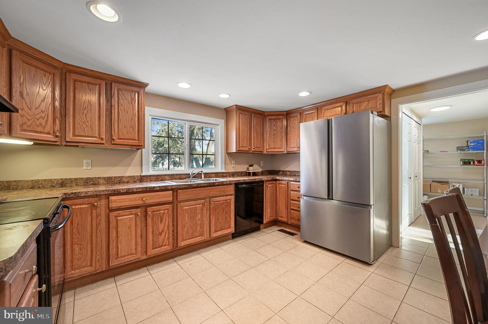 12739 Greensboro Road Greensboro, MD 21639 - Photo 9 of 28 a kitchen with stainless steel appliances granite countertop a refrigerator sink and cabinets