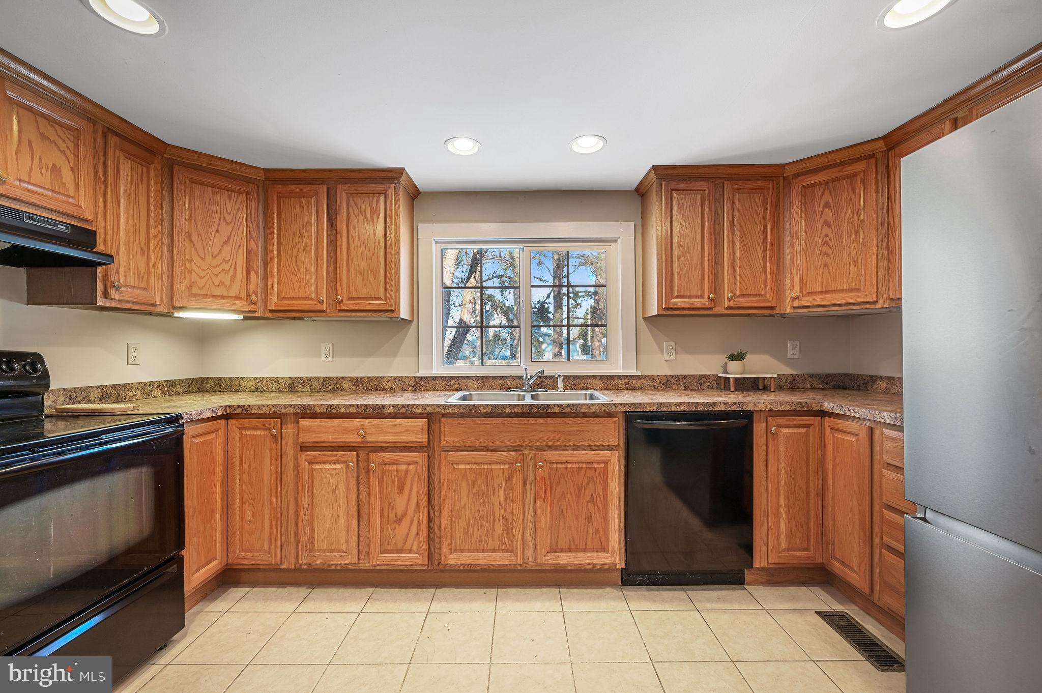 12739 Greensboro Road Greensboro, MD 21639 - Photo 10 of 28 a kitchen with a sink stove top oven and cabinets