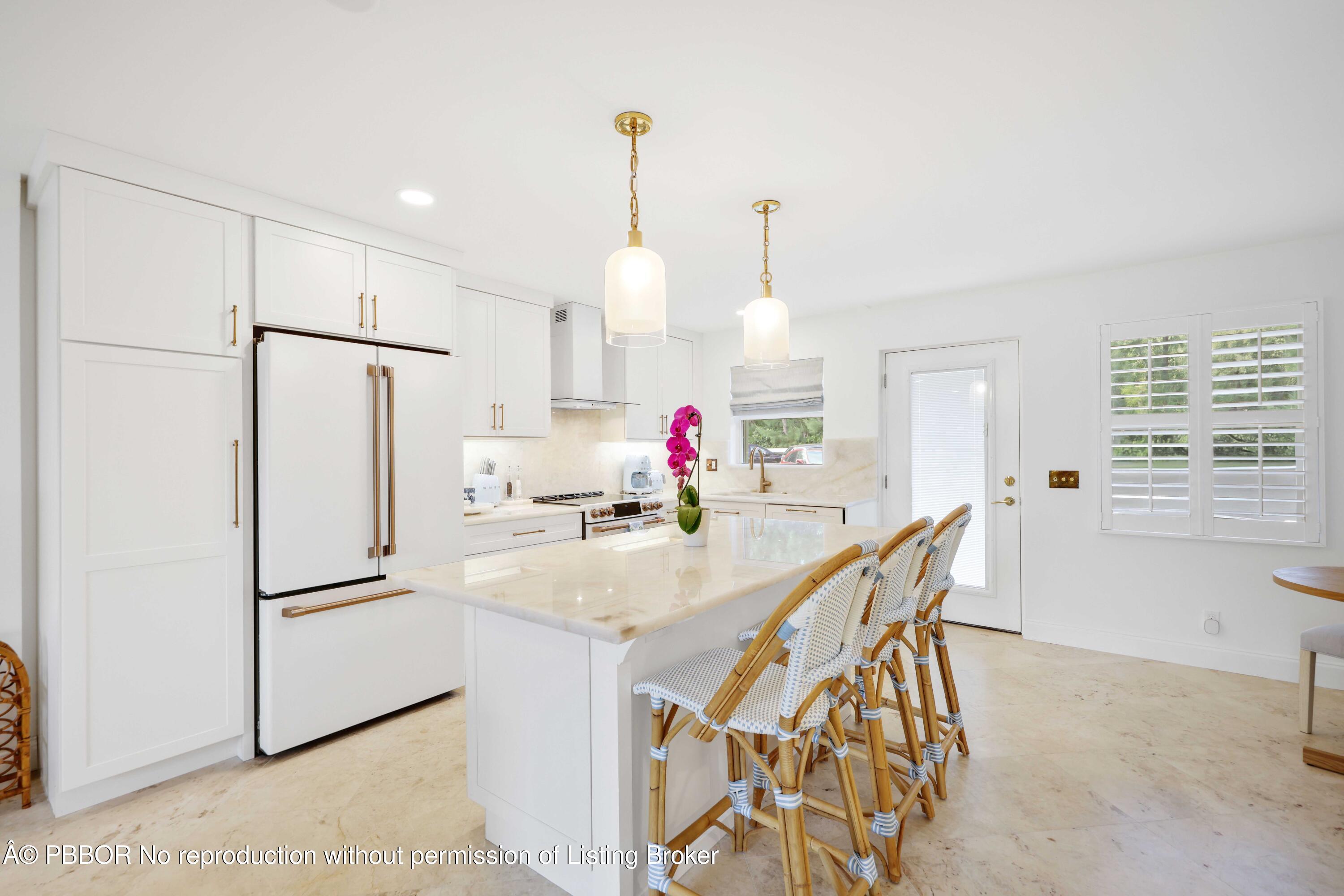 Undisclosed Address Palm Beach, FL 33480 - Photo 11 of 43 a kitchen with stainless steel appliances granite countertop a refrigerator a sink a dining table and chairs