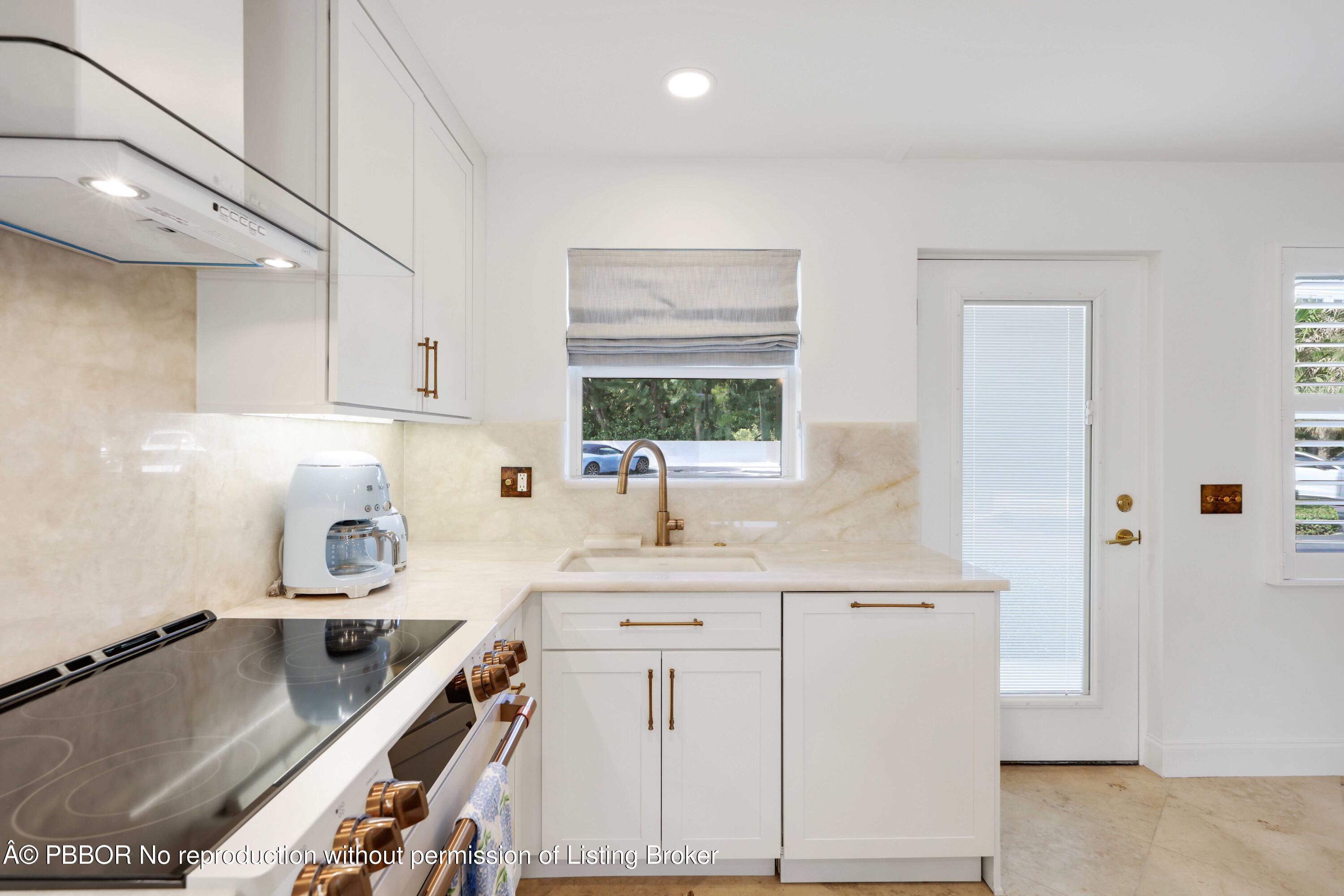 Undisclosed Address Palm Beach, FL 33480 - Photo 9 of 43 a kitchen with a sink stove and cabinets
