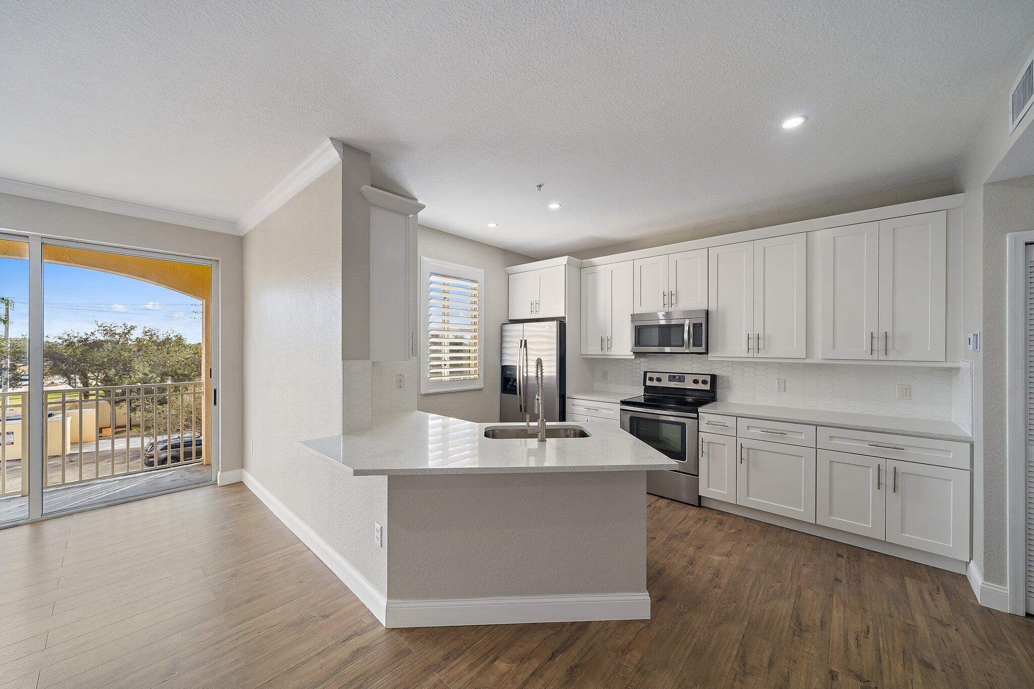 11010 Legacy Drive, Unit 302 Palm Beach Gardens, FL 33410 - Photo 1 of 20 a large kitchen with cabinets