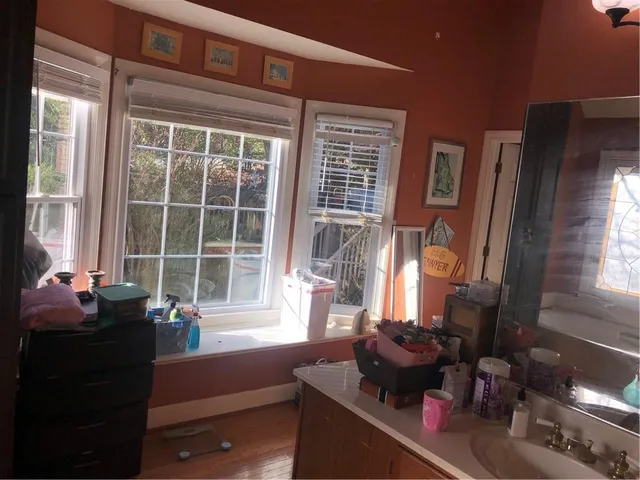 a bedroom with furniture and a flat screen tv