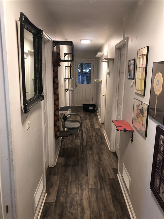 4532 High Rock Terrace Marietta, GA 30066 - Photo 19 of 40 a view of a hallway with wooden floor and staircase