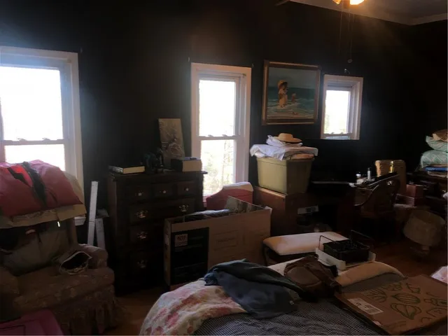 a bedroom with a bed and a chandelier