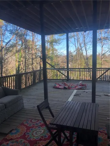 a bedroom with a bed and a flat tv screen on the table