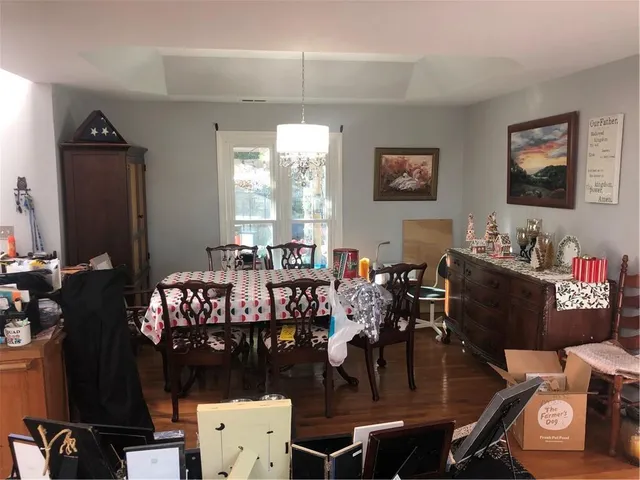 a kitchen with a sink dining table and chairs