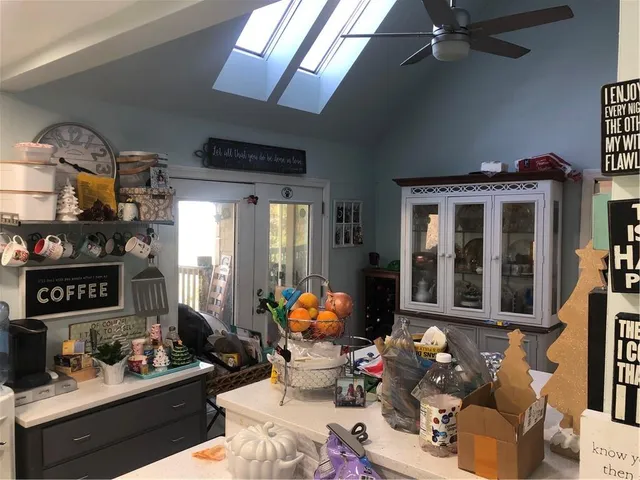 a room with stainless steel appliances kitchen island granite countertop a stove and a microwave