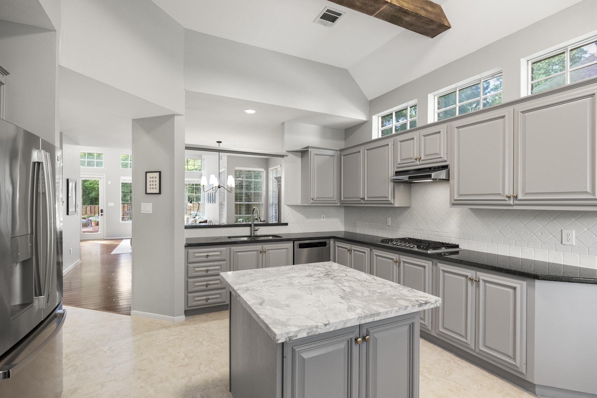 102 Treescape Circle Spring, TX 77381 - Photo 6 of 40 High ceilings and ample natural light create a spacious feel, with an open view to a bright dining area and outdoor patio.